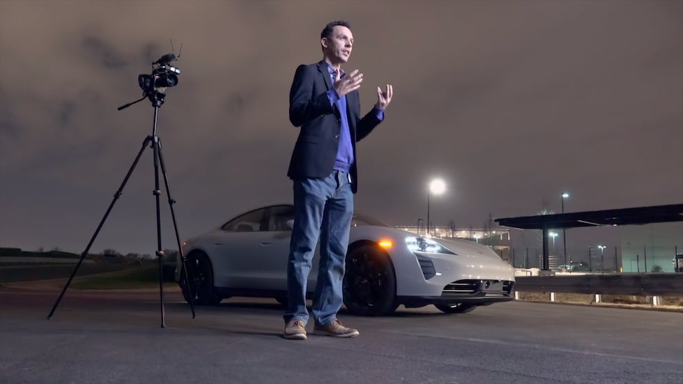 A photo of Frank Wiesmann from Porsche North America standing in front of a white Porsche with...